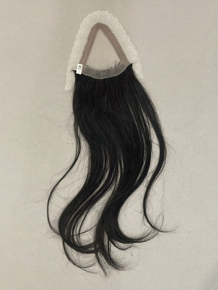 A 13 by 4 lace frontal laid flat on grey paper