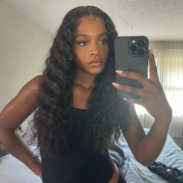 Customer mirror selfie wearing a long body wave unit